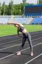 Warm up the girl before running, stretching training in running stadium. People sport and fitness concept Royalty Free Stock Photo