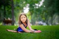 Warm-up in the park girl doing stretching Sitting in twine on the lawn in the park