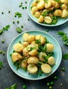 Warm vegetarian new baby potato salad with petit pois peas, Dijon mustard and capers dressing, served with fresh dill