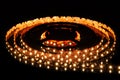 Warm white LED strip on reel with black background Royalty Free Stock Photo