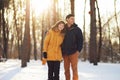 Warm winter portrait of a couple of different race in the forest