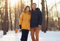 Warm winter portrait of a couple of different race in the forest