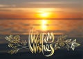 Warm wishes, vector lettering, handwritten golden text and floral elements on blurred background of sea sunset