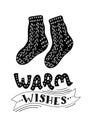 Warm woollen knitted sockes with lettering `Warm wishes`.