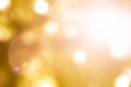 Warm yellow gold color of blurred sky background with nature glowing sun light flare and bokeh Royalty Free Stock Photo