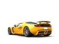 Warm yellow modern supercar - tail view Royalty Free Stock Photo