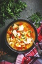 Warming autumn soup with red lentils, chicken fillet, vegetables, spices and paprika, comfort food. Green table, top view Royalty Free Stock Photo