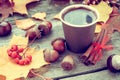 Warming coffee cup and autumn still life on table