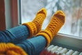 Warming Feet on White Radiator, Man Warms his Feet at Home, Cold Winter, Expensive Electricity Saving Concept