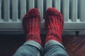 Warming Feet on White Radiator, Man Warms his Feet at Home, Cold Winter, Expensive Electricity Saving Concept