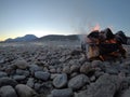 Warming fire on frozen cold white river shore