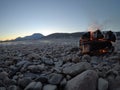 Warming fire on frozen cold white river shore