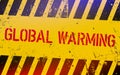 Global warming lettering on danger sign with yellow and black stripes. Royalty Free Stock Photo