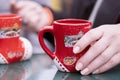 Close-up of woman holding glass cup of delicious white mulled wine in her hands.A girl holds a cup of mulled wine in her hands. Royalty Free Stock Photo