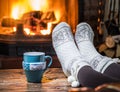 Warming and relaxing near fireplace with a cup of hot drink. Royalty Free Stock Photo