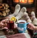 Warming and relaxing near fireplace with a cup of hot drink. Royalty Free Stock Photo