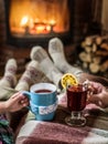 Warming and relaxing near fireplace with a cup of hot drink. Royalty Free Stock Photo