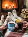 Warming and relaxing near fireplace with a cup of hot drink. Royalty Free Stock Photo