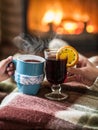 Warming and relaxing near fireplace with a cup of hot drink. Royalty Free Stock Photo