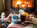 Warming and relaxing near fireplace with a cup of hot drink. Royalty Free Stock Photo