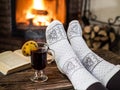 Warming and relaxing near fireplace with a cup of hot wine and a book Royalty Free Stock Photo