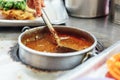 Warming satay sauce in the pot. Satay is a dish of skewered grilled meat with Javanese origins in Malacca City, Malacca, Malaysia Royalty Free Stock Photo