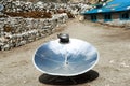 Warming the teapot in a solar cooker. Nepal. Himalaya