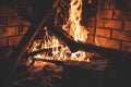 Warming up by the fire, cozy winter night in the cabin by the fireplace, fire burns in the scandinavian cottage, burning fire with