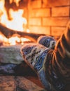 Warming up the fire, cozy winter night in the cabin house by the fireplace, fireplace burns in the scandinavian chalet cottage, Royalty Free Stock Photo