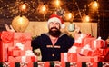 Warming up. Tea time. Man bearded santa claus hat drinking hot beverage. Hipster prepared gifts for family. Generous new