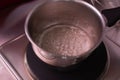 Professional baker warming whites of egg for cooking meringue