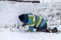 Warmly dressed boy playing with snow Royalty Free Stock Photo