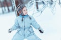 Warmly dressed boy playing in winter forest Royalty Free Stock Photo