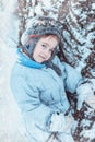 Warmly dressed boy playing in winter forest Royalty Free Stock Photo