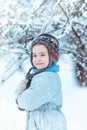 Warmly dressed boy playing in winter forest Royalty Free Stock Photo