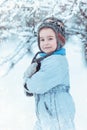 Warmly dressed boy playing in winter forest Royalty Free Stock Photo