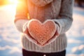 Warmly Dressed Girl Embracing a Knitted Red Heart in Winter - Generative AI