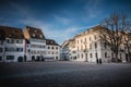 Warmly dressed people walk on cathedral square of Basel