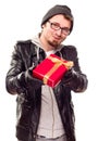 Warmly Dressed Young Man Handing Wrapped Gift Out