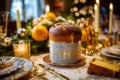 Holiday cake sits on a table with plates, silverware, fruit and candles with a festive Christmas tree in the background. Royalty Free Stock Photo