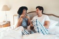 He warms up my heart every morning. an affectionate young couple drinking coffee and spending time together in bed at Royalty Free Stock Photo