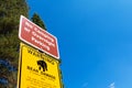 Warning bear damage sign informs tourists about possible car damage on parking lot while leaving food inside the vehicle