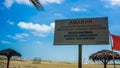 The warning board for the tourist that come to the Batu Burok Beach to swim at their own risk Royalty Free Stock Photo