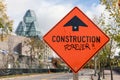 Warning construction ahead orange road sign in downtown of Ottawa