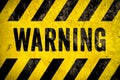 Warning danger sign word text as stencil with yellow and black stripes painted over concrete wall cement texture background Royalty Free Stock Photo