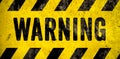 WARNING danger sign word text as stencil with yellow and black stripes painted over concrete wall cement texture background Royalty Free Stock Photo