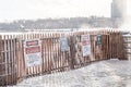 Warning danger signs on a fence for winter icy conditions Royalty Free Stock Photo