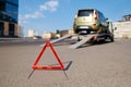 Warning foldable triangle placed before tow track