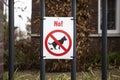 Warning label, No dog pooping sign in park for dog owners Royalty Free Stock Photo