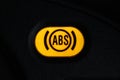 Warning light of the anti-lock braking system -ABS on the dashboard of the car.